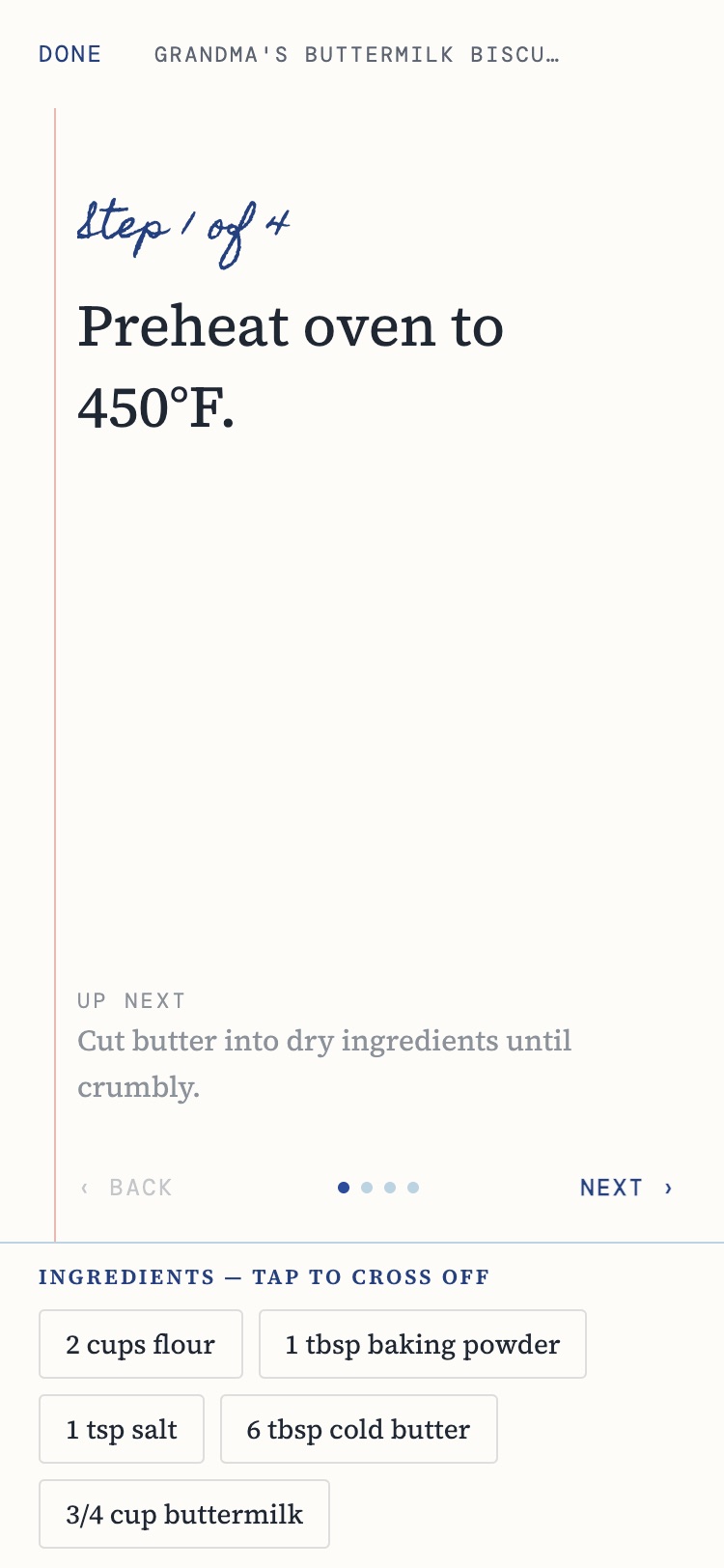 Cook mode in Kouzina: 'Step 1 of 4' in blue handwriting, 'Preheat oven to 450°F' in large type, the next step below, and ingredient chips to tap and cross off